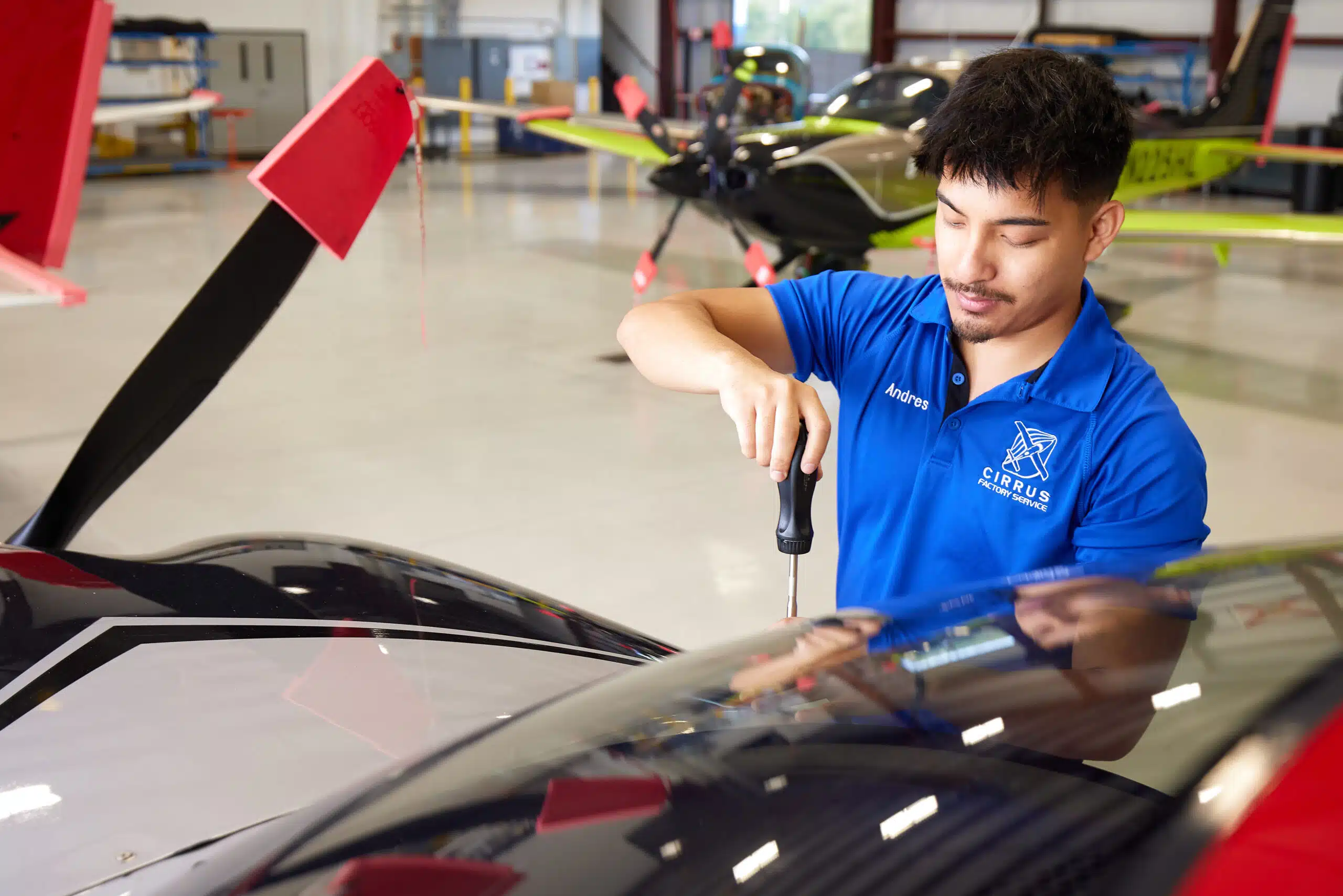 man servicing a cirrus plane